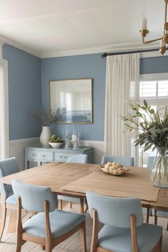 a dining room with blue chairs and a wooden table