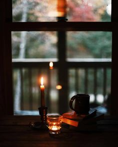 a candle that is sitting in front of a window with the words good night written on it