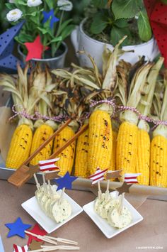 corn on the cob with toothpicks and american flag decorations at a fourth of july party