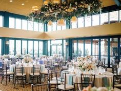 a banquet hall with tables and chairs set up for an event