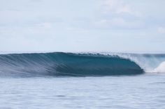 a large wave in the middle of the ocean