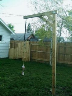 a wooden structure in the middle of a yard