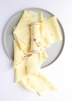 slices of cheese on a plate with some crackers