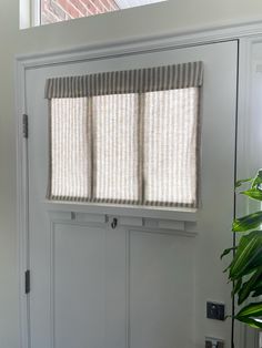 We are proud to say this product is custom made in the USA; made with care, using a high-quality, hand-picked fabric.   Enjoy convenience and style with our Small Front Door or Sidelight Curtains. Designed for ease of use, simply fold or roll up in seconds. These curtains are more than just entryway coverings; they elevate your space. With no cords or holes, installation is a breeze, requiring only our provided Adhesive Hook & Loop Fastener strip, eliminating the need for hardware, putting no holes in your door. Fabric Description and Content: This Taupe Striped Fabric is a medium weight and very soft. The background color is a beige, creamy oatmeal color and the stripe is a grayish tan color. This fabric allows a lot of light through, but still gives full privacy, even at night. Made from Front Door Window Valance, Mobile Home Door Window Curtain, Front Door Side Window Blinds, Half Glass Door Window Treatments, Fabric Door Covers, Front Door Roll Up Shade, Laundry Door Curtain, Mini Blinds For Front Door, Door Small Window Treatments