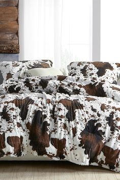 the comforter is made up with brown and white cow print