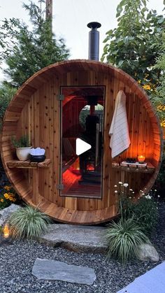 an outdoor sauna is shown in the garden