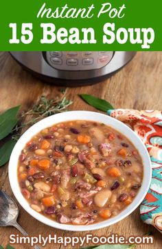 instant pot bean soup in a white bowl on a wooden table next to an instant pot