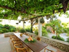 an outdoor dining area with wooden tables and chairs