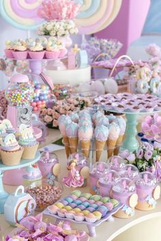 a table filled with lots of cupcakes and desserts on top of it