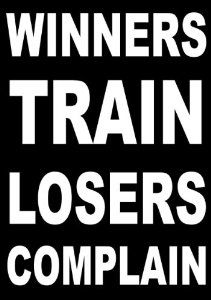 a black and white sign with the words winners train, losers complain