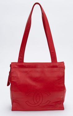 Vintage Chanel tote bag from the 90s in red. The bag shows a big CC hedged logo on front of it. The shoulder drop is 11.5". The piece has a hologram and comes with a generic dust cover. Red Shoulder Bag With Logo, Red Logo Shoulder Bag, Red Tote Bag With Logo, Red Rectangular Bag With Logo, Red Rectangular Bags With Logo, Chanel Tote Bag, Chanel Tote, Chanel Vintage, Vintage Chanel