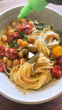 a white bowl filled with pasta and vegetables