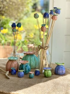 vases with flowers in them sitting on a table next to a window sill