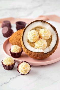 a pink plate topped with coconuts and cupcakes