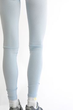 The Cora Ribbed Leggings have the stretch, comfort, and sculpting needed for everyday wear. Fabric that is soft to the touch and perfectly colored with a repeating sky blue and white. Pair Cora with any of our Azurro colorway for a complete look. Full length Squat proof Heavyweight rib Layered sky blue and white ribbed fabric YLLW custom trim in white and gold Inseam length on size XS: 28.5" 57% nylon, 37% polyester, and 6% spandex Your order will ship from our warehouse in FL, USA! Spring High Stretch Ribbed Leggings, High Stretch Ribbed Leggings For Spring, Spring Loungewear Footless Bottoms, High Stretch Ribbed Pants For Spring, Ribbed Tight Bottoms For Loungewear, Casual Ribbed Yoga Bottoms, Blue Ribbed Casual Bottoms, High Stretch Light Blue Casual Leggings, Tight Ribbed Athleisure Bottoms