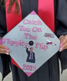 a person in a graduation cap and gown holding up a sign that says catch you on the trippy flip