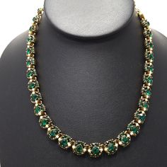 *Description: This is a gorgeous Hollycraft emerald green gold plated rhinestone choker necklace with an antique gold finish with tiny faux pearls on each link from the 1950s. This mid century necklace is stamped on the back HOLLYCRAFT Copr. 1953 which means that it was in production in 1953. The necklace is 16 1/4 Inches in length and it can be adjusted to a shorter length with the rhinestone extension and hook clasp. The rhinestones are emerald green in color and the rhinestones on the extensi Vintage Jeweled Choker Necklace, Vintage Green Evening Jewelry, Vintage Gold Emerald Necklace For Formal Occasions, Vintage Green Jeweled Jewelry, Victorian Green Jewelry For Party, Vintage Green Necklaces For Evening, Vintage Green Necklace For Evening, Vintage Green Jeweled Necklaces, Green Rhinestone Necklace For Formal Occasions