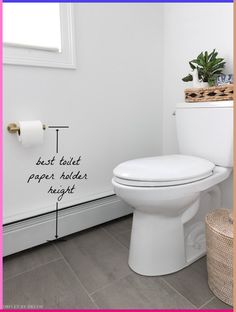 a white toilet sitting in a bathroom next to a wall with words written on it