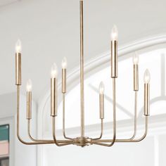 a gold chandelier with candles hanging from it