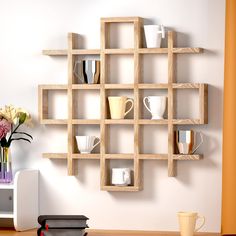 a wooden shelf filled with cups and vases