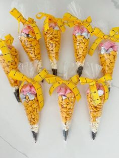 seven cones with measuring tape wrapped around them are arranged in the shape of corn kernels