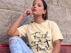 𝗙𝗔𝗜𝗧𝗛 𝗢𝗩𝗘𝗥 𝗙𝗘𝗔𝗥 𝗦𝗛𝗜𝗥𝗧! Step into a life of confidence and positivity with our "Faith Over Fears" Shirt! It is a true statement of strength, courage, and unwavering faith. Whether you're facing challenges or want to spread a message of hope, this tee is the perfect way to keep those inspiring vibes close to your heart! *I T E M D E T A I L S: UNISEX T-SHIRT: *The shoulders have taping for a better fit over time. *Light fabric *Tear away label *Runs true to size *CARE INSTRUCTIONS* +Turn Garment Inside Out +Machine Wash On Cold +No Fabric Softeners +No Bleach +Tumble Dry On Low +Do Not Iron Over The Design ** N O T E T O B U Y E R ** Due to differences between monitors, the colors on the screen may vary and appear slightly different in person! 𝗣𝗹𝗲𝗮𝘀𝗲 𝗖𝗢𝗡𝗧𝗔𝗖𝗧 𝗠 Inspirational Short Sleeve Shirt With Relaxed Fit, Inspirational Short Sleeve Relaxed Fit Shirt, Faith Over Fear Shirt, Unwavering Faith, Church Shirt, Faith Tees, Facing Challenges, Jesus Shirt, Message Of Hope