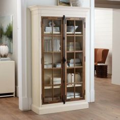 a tall cabinet with glass doors in a living room