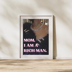 a framed poster with the words mom, i am a rich man in pink and black