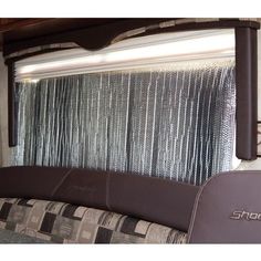 the inside of an rv with curtains on it