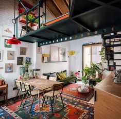 a living room filled with furniture and lots of plants on top of it's shelves