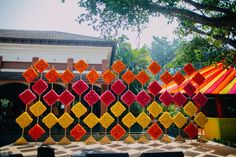 an artistic display in front of a building with lots of colorful decorations on the outside