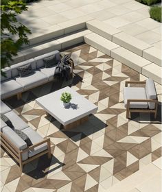 an aerial view of a patio area with couches, tables and chairs on it