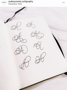 an open notebook with cursive writing on it