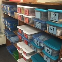 the shelves are filled with plastic containers and bins for numbers to be placed on