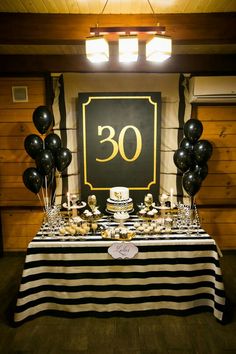 a table topped with black and white desserts next to a sign that says yes is free