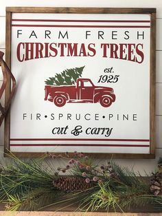 a red truck with a christmas tree on the back sits in front of a sign that reads farm fresh christmas trees