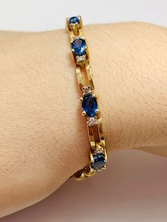 Beautiful Vintage 14K Yellow Gold Diamond and Oval shape Sapphire Bracelet: Stunning Genuine Diamonds and Natural Oval Sapphires Sapphire(s): 11 pc 8.0 CT Diamond(s): 0.20 CT Color: F Clarity: SI1 Total Bracelet Weight: 11.1 GR Bracelet Length: 7in Bracelet Width: 5 mm 14K Yellow Gold For more information regarding this item feel free to reach me so I can accommodate your needs. Thank you Oval Gold Bracelet With Gemstone For Formal Occasions, Formal Oval Gold Bracelet With Gemstones, Oval Gold Gemstone Bracelet For Formal Occasions, Formal Oval Gold Bracelet With Diamond Accents, Blue Gold Bracelet With 17 Jewels For Formal Occasions, 14k Gold Tennis Bracelet For Formal Occasions, Formal Oval Gold Gemstone Bracelet, 14k Gold Tennis Bracelet With Gemstones For Formal Occasions, Formal 14k Gold Hand Set Bracelets