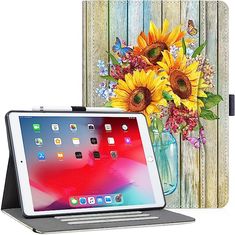 an ipad case with sunflowers in a vase and flowers on the back cover