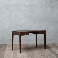 a small wooden table with two drawers on one side and an open drawer on the other