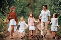 a family walking down a dirt road holding hands