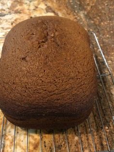 a loaf of chocolate cake cooling on a rack