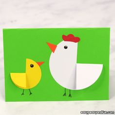 an origami card with two chickens on it