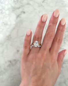 a woman's hand with a diamond ring on it