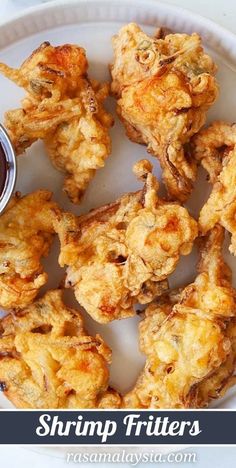 fried food on a white plate with dipping sauce in the middle and words shrimp fritters above it