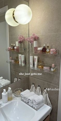 a bathroom sink sitting under a mirror next to a shelf filled with personal care items