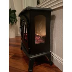 a small black stove sitting on top of a hard wood floor