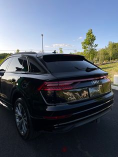 an audi suv parked in a parking lot