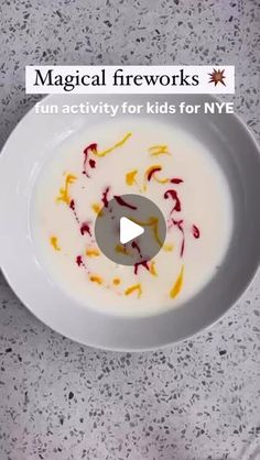 a white bowl filled with liquid on top of a table