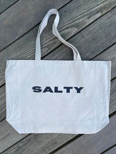 Stay salty no matter the season with the Salty Tote Bag! This extra large bag is perfect for carrying all the essentials — and then some. Bring it to the beach, farmer's market, campus, or run errands. This one can do it all and bring you beach style no matter where you go. Measures 20"W x 15"H x 5"D Stay Salty, Farmer's Market, Bring It, Large Bag, Beach Style, Do It, Extra Large, The Beach, Matter