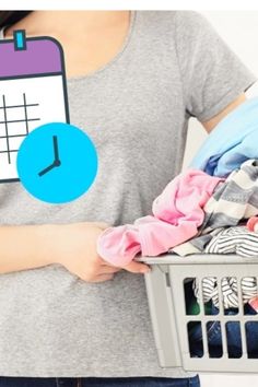 a woman holding a laundry basket with clothes in it and a clock on the wall